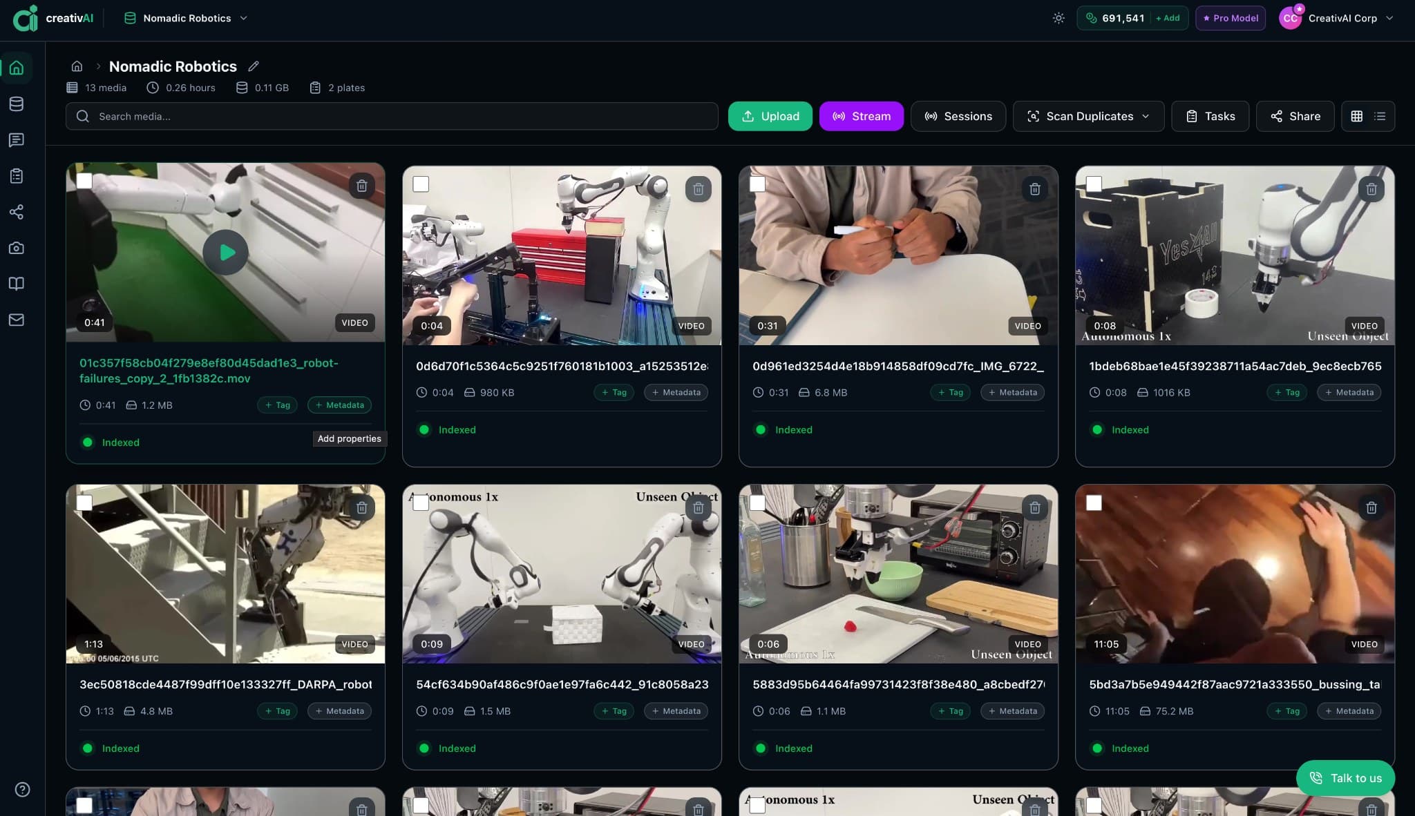 CreativAI's media library for a robotics collection: a grid of robot video clips, from arms handling objects to a humanoid, each tagged Indexed, with Upload, Stream and Scan Duplicates controls above.