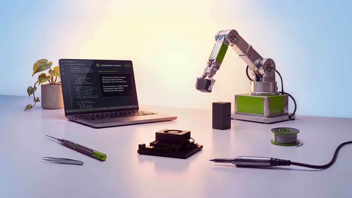 An Nvidia Jetson Orin Nano 2 module on a desk beside a laptop and a small robotic arm.