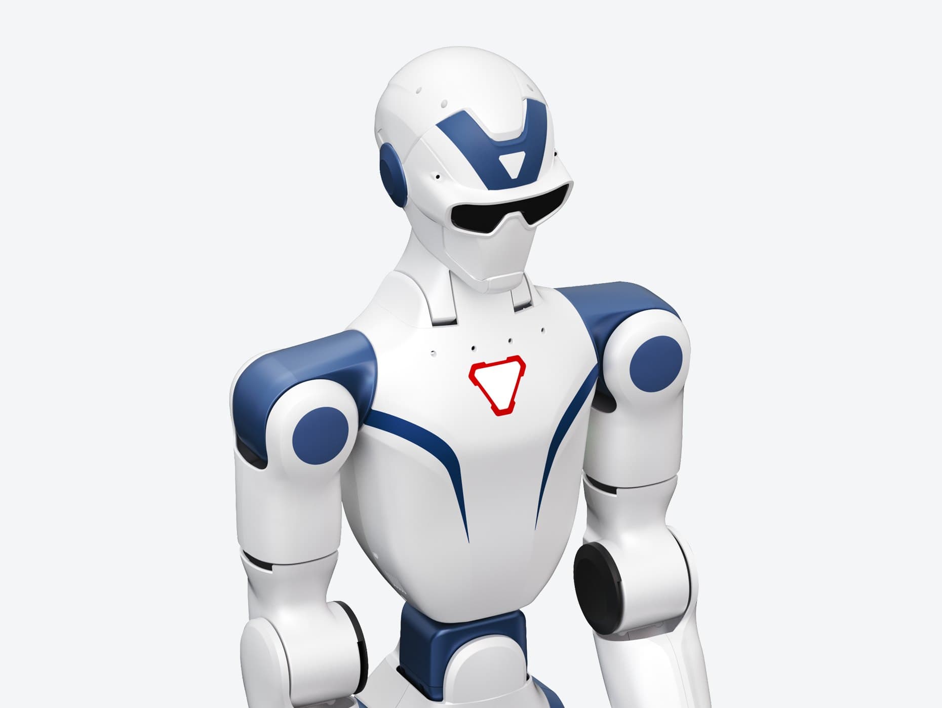 The upper body of Unitree's R1 humanoid, white with dark blue shoulder joints and head panels, black visor-style eyes and a red triangle logo on its chest.